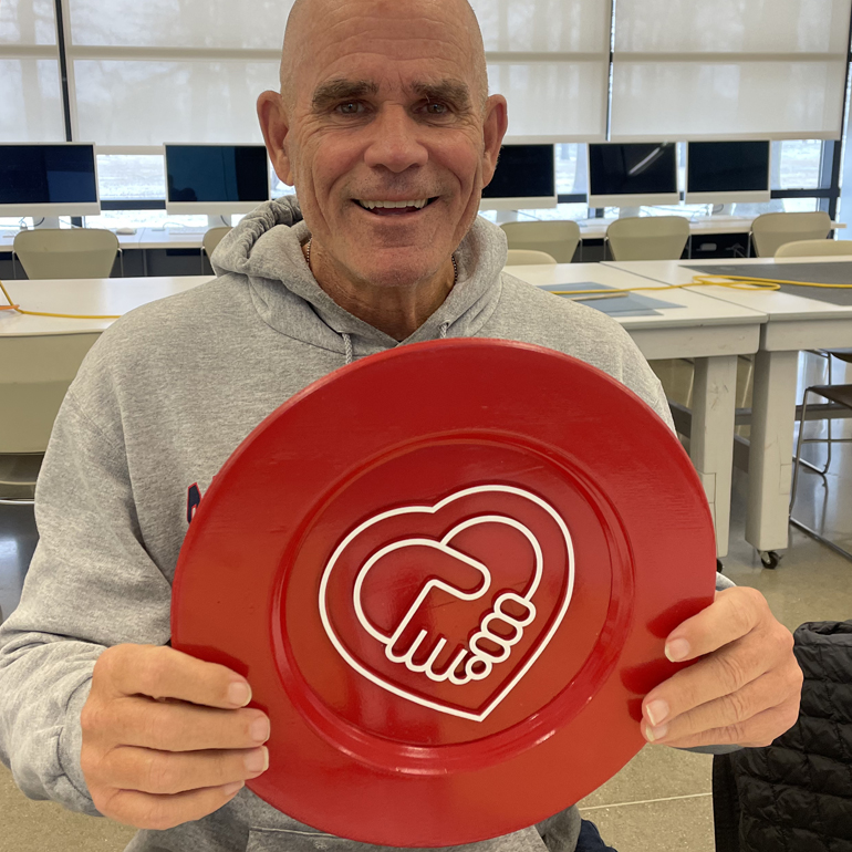 Photograph of Jim Dwyer holding a HSC Plate